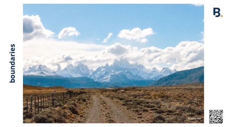 boundaries as in fence lining a road that seems to lead directly towards a range of peaks and an inland ice shield