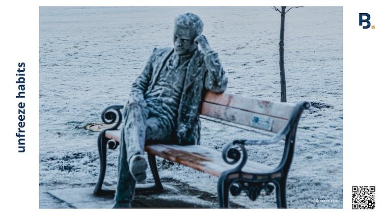 Frozen as in a statue covered in frost on a bench