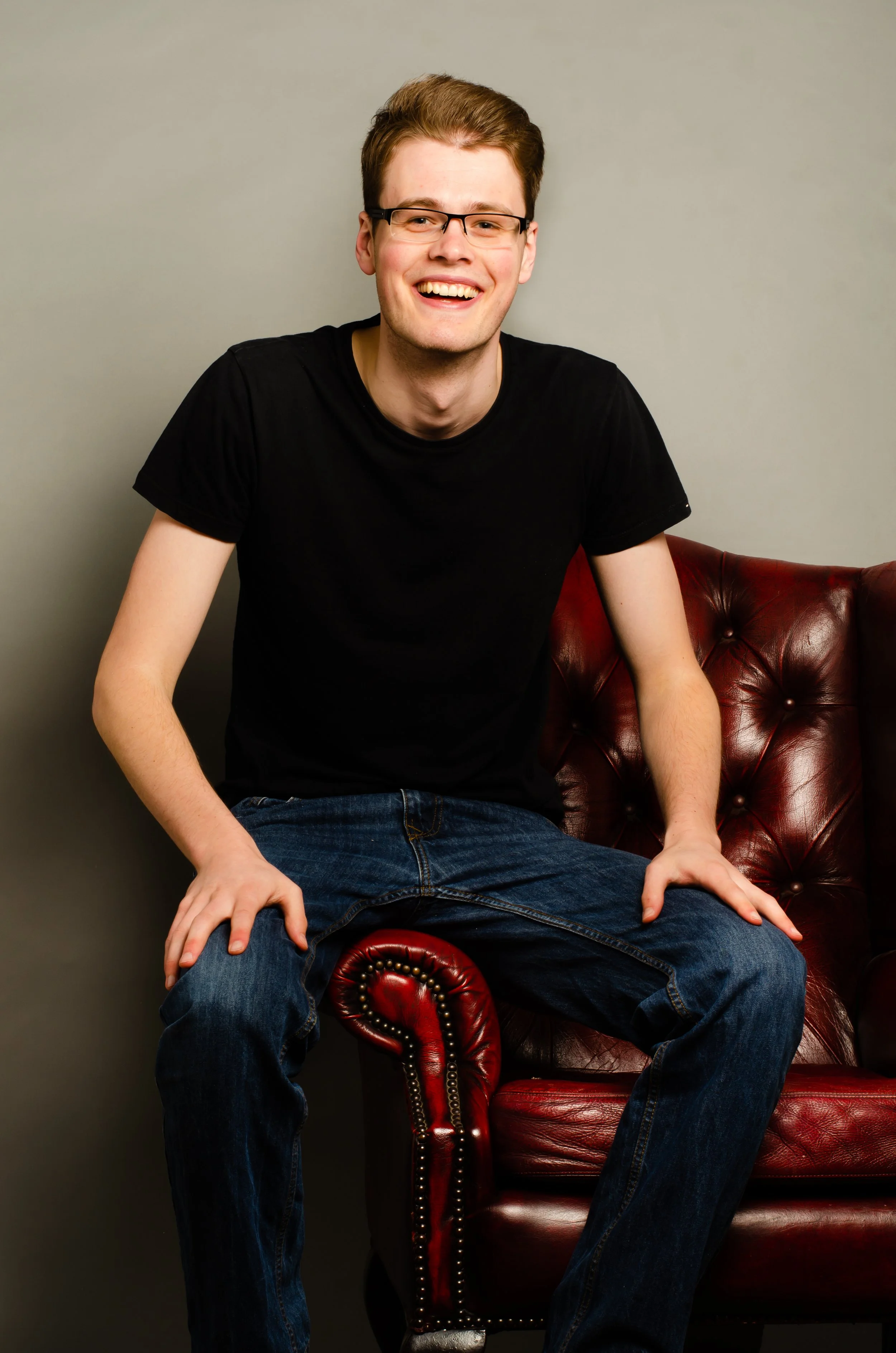 Photo of Kieran perched on an ornate armchair.
