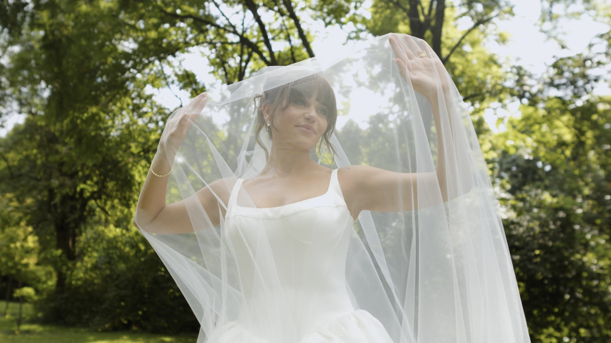 A bride poses underneath her veil after her wedding ceremony. Shot and edited by Colson Studio Productions in Cincinnati, Ohio.