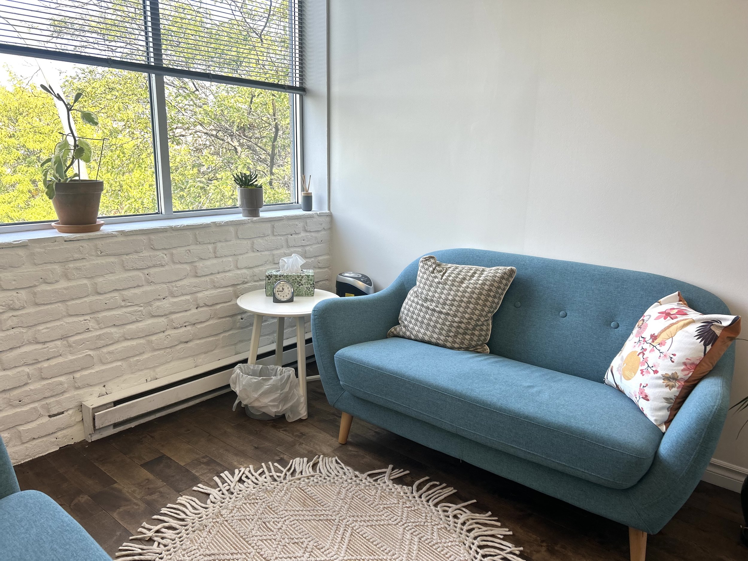 Office 1: This sunlit and cozy private clinical office is equipped with an armchair, loveseat, desk, office chair, and air purifier. Ideal for individual sessions, but can accommodate couples as well.