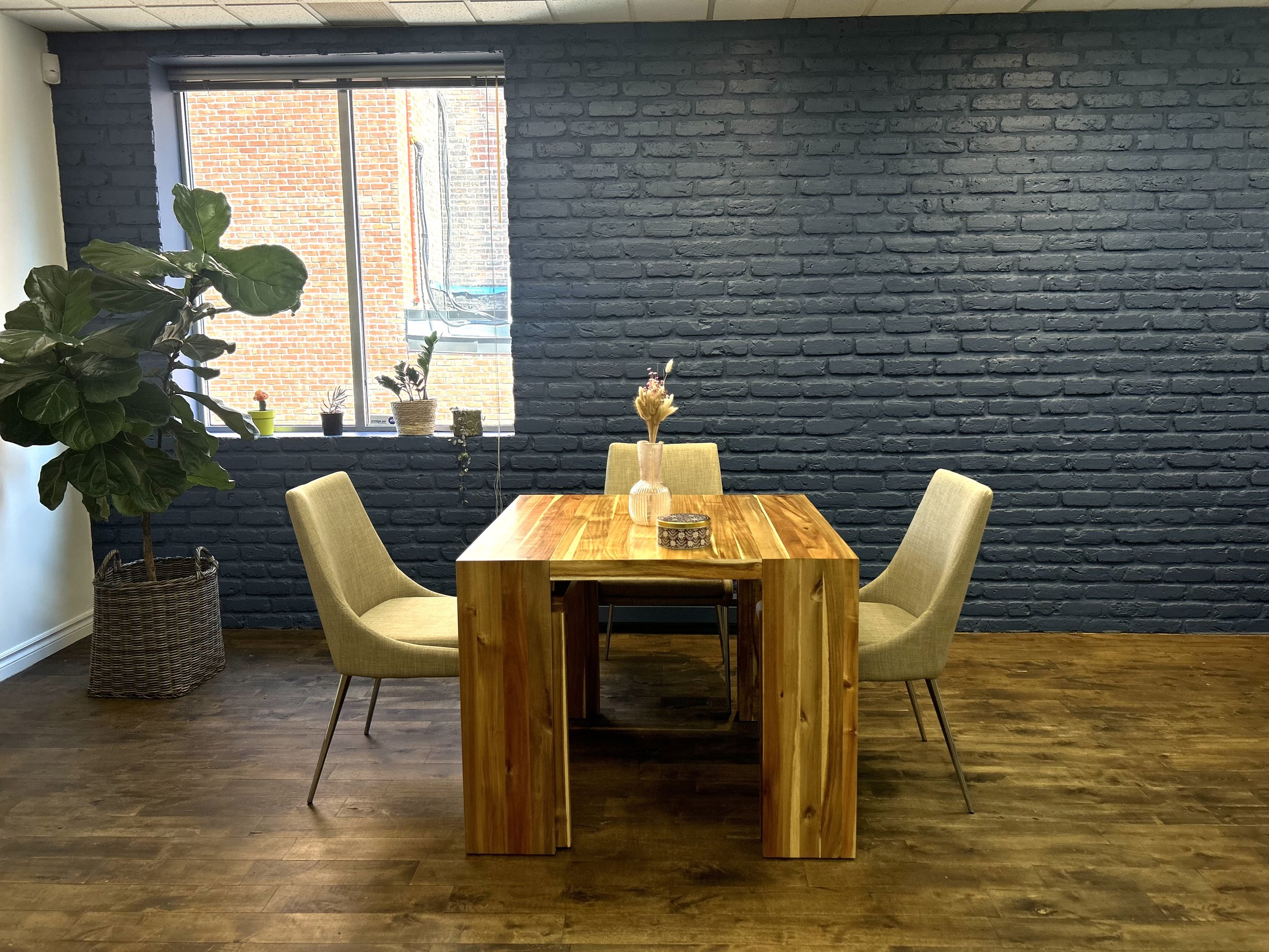 Our communal space serves as both a patient waiting area and a collaborative space for clinicians, where they can hold group meetings and work together. It includes comfortable seating, a table and chairs, along with a kitchen equipped with a fridge,