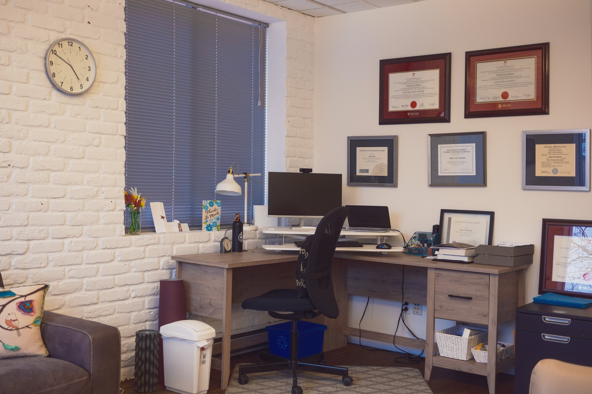 Office 3: This bright and spacious corner office is ideal for individual or couple sessions. Equipped with comfortable seating including an armchair, loveseat, desk, office chair, and air purifier. Features calming artwork and abundant greenery.
