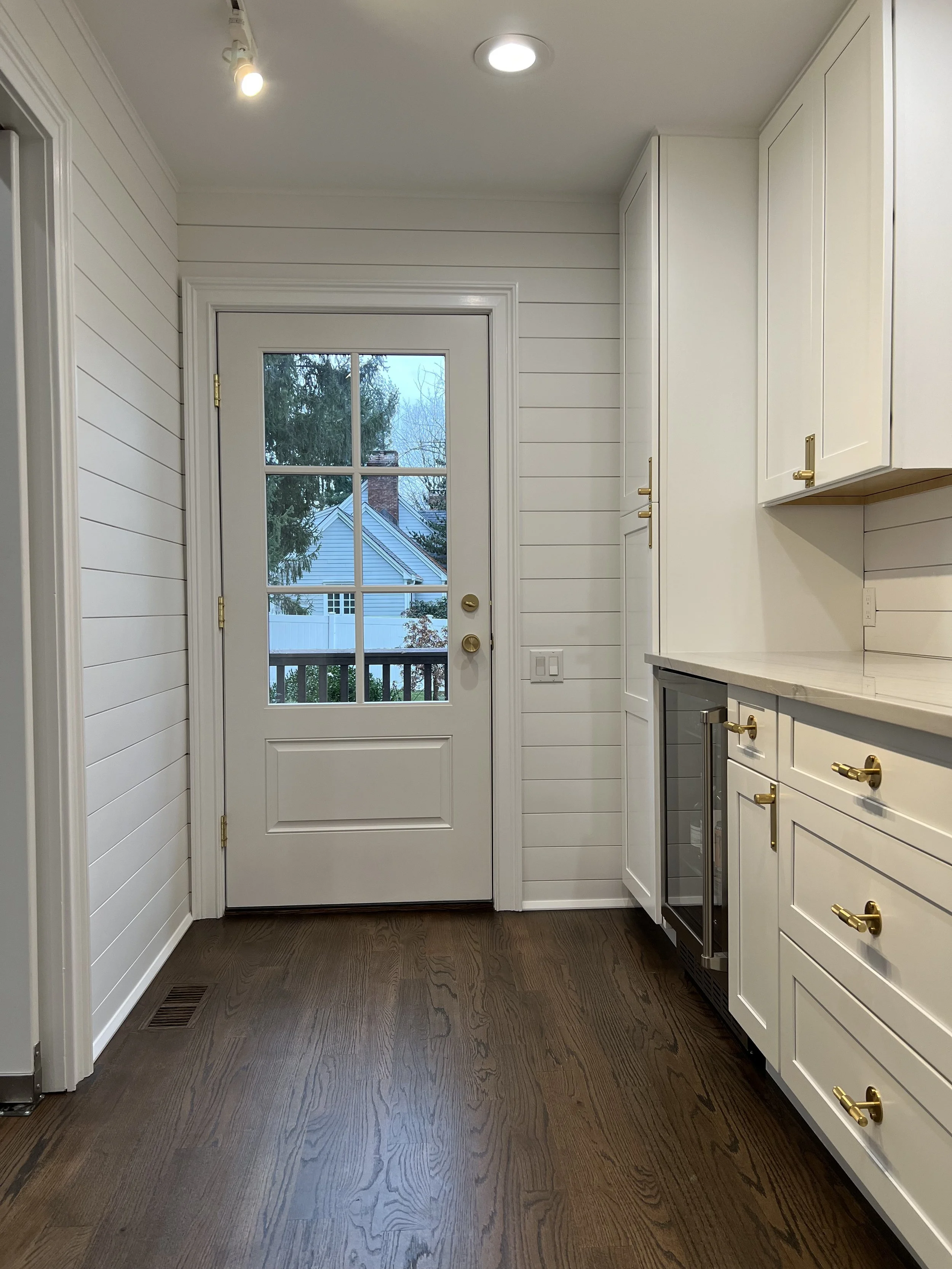 Bright Traditional Cottage Style Kitchen With White Cabinetry, Shiplap Walls, Brass Hardware, And Dark Wood Flooring Kitchen Remodel by Azimuth Home Improvements LLC project photo 3