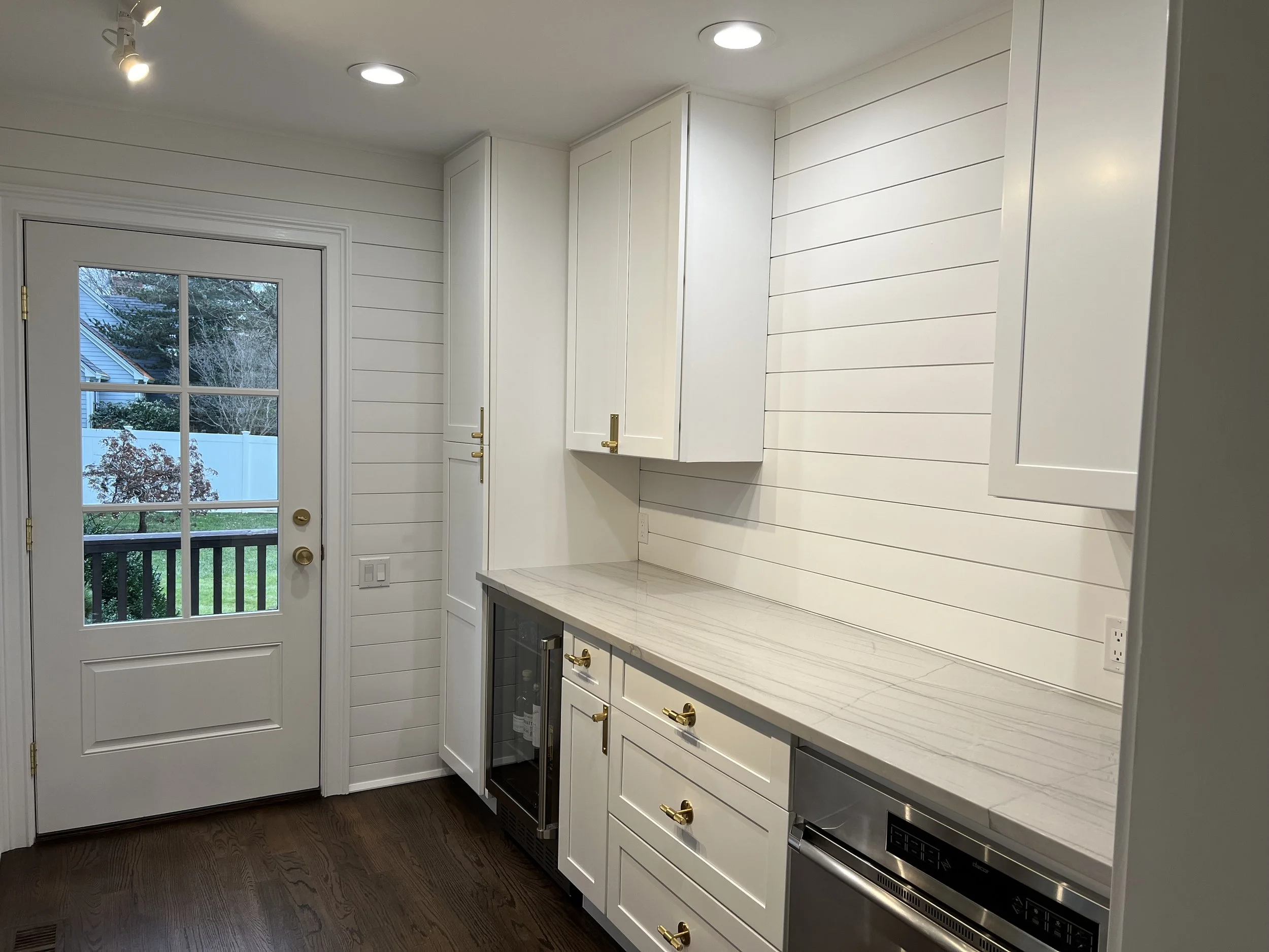 Bright Traditional Cottage Style Kitchen With White Cabinetry, Shiplap Walls, Brass Hardware, And Dark Wood Flooring Kitchen Remodel by Azimuth Home Improvements LLC project photo