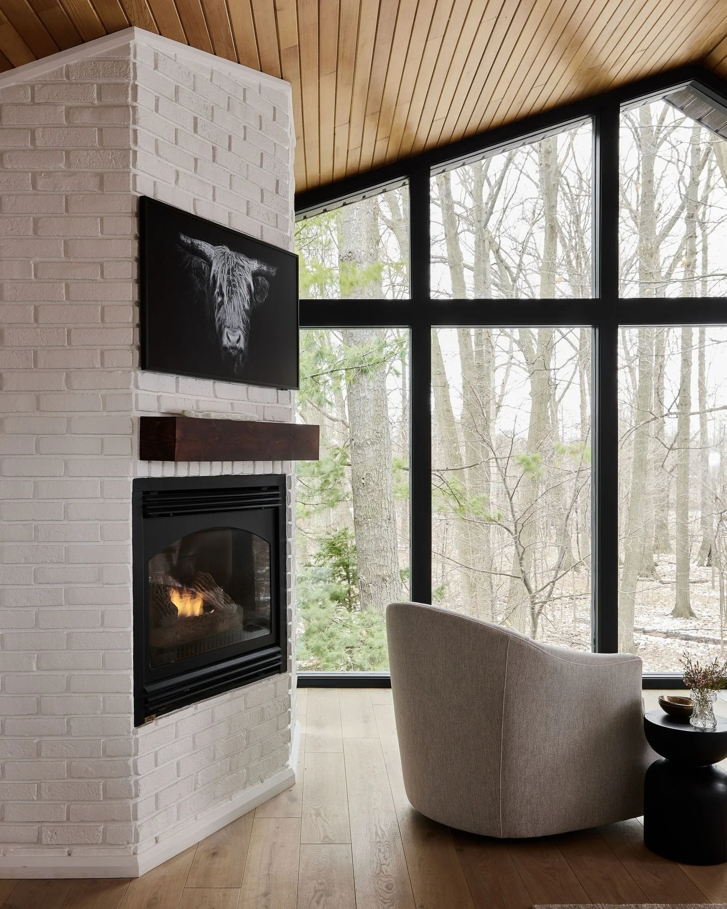 Enjoying the snowy view from this primary bedroom sitting area ❄️ 🔥 

Swipe to see the before and during construction 

Designed by DebraLillianDesign @debra_salmoni 
Photography 📸 @lomillerphoto 
Styling @_meandmo_