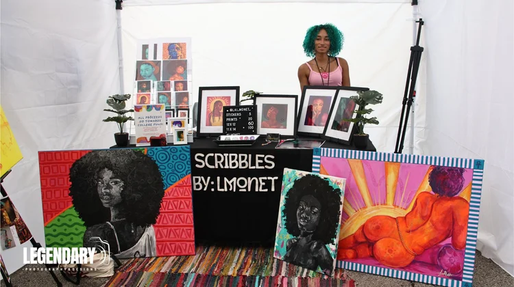 An artist beside a booth filled with artwork. 18th & Vine Arts Festival 2026.