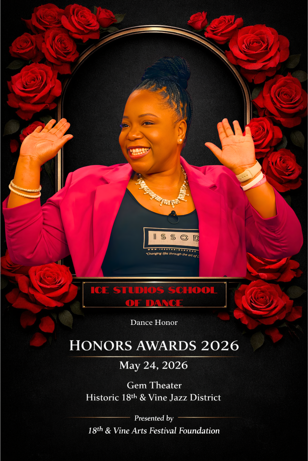 Woman smiling with hands raised, wearing a pink blazer, black shirt with white text, necklace and bracelets, standing in front of a backdrop decorated with red roses, announcing the ICE Studios School of Dance Honors Awards 2026 on May 24, 2026, at Gem Theater in the Historic 18th & Vine Jazz District.