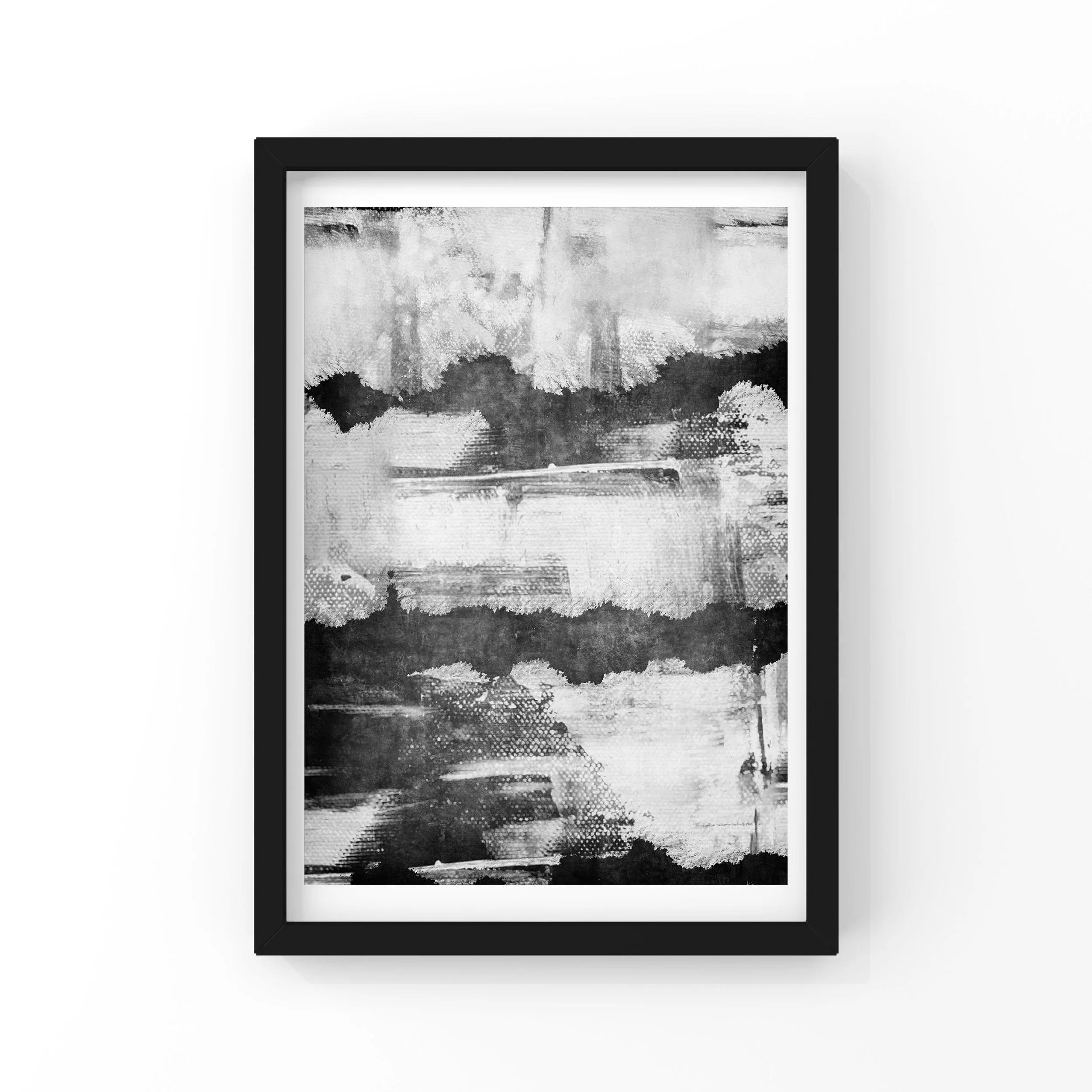 Black and white abstract artwork in a black frame on a white wall.