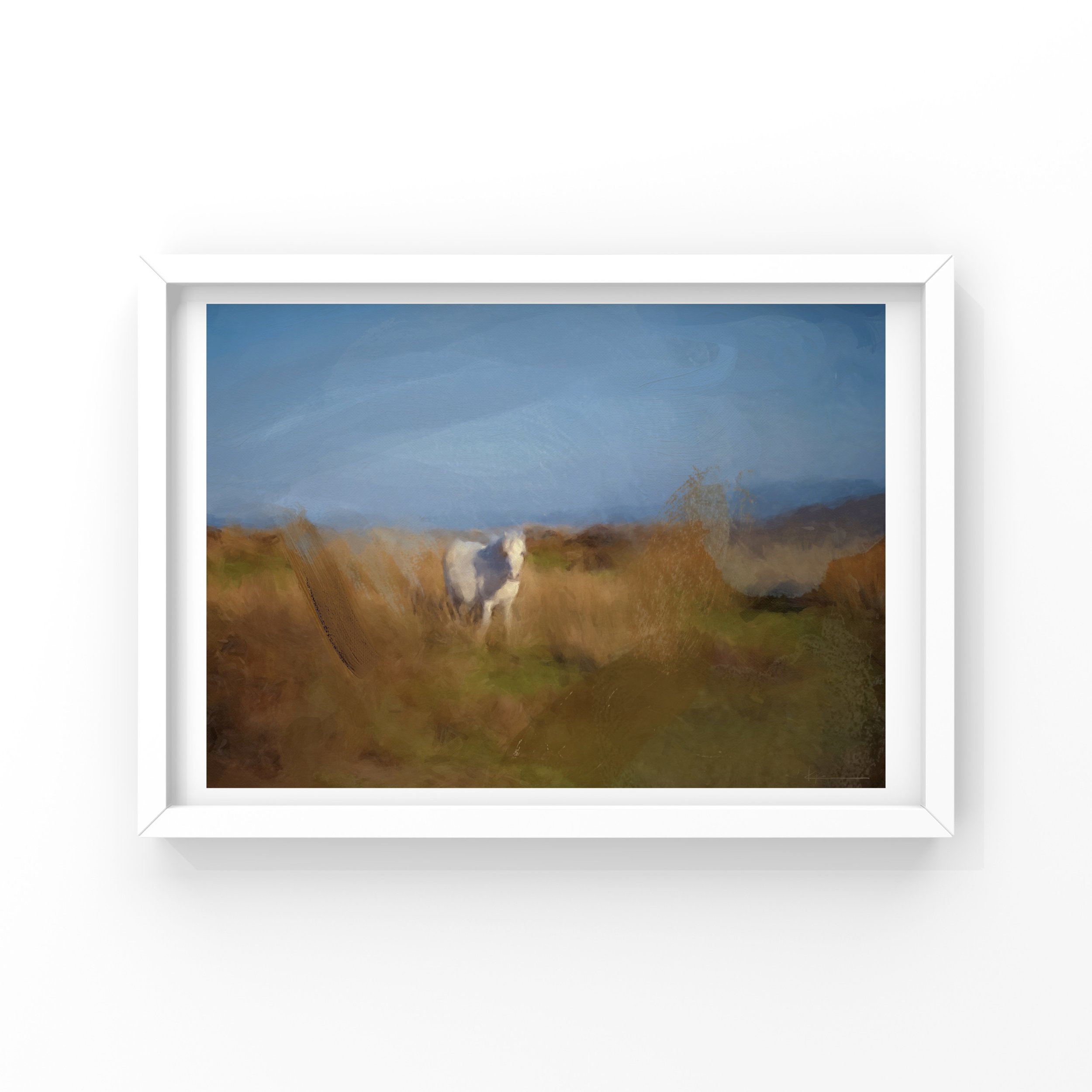 A framed landscape painting featuring a blue sky, distant mountains, and a grassy field with a white dog in the foreground.