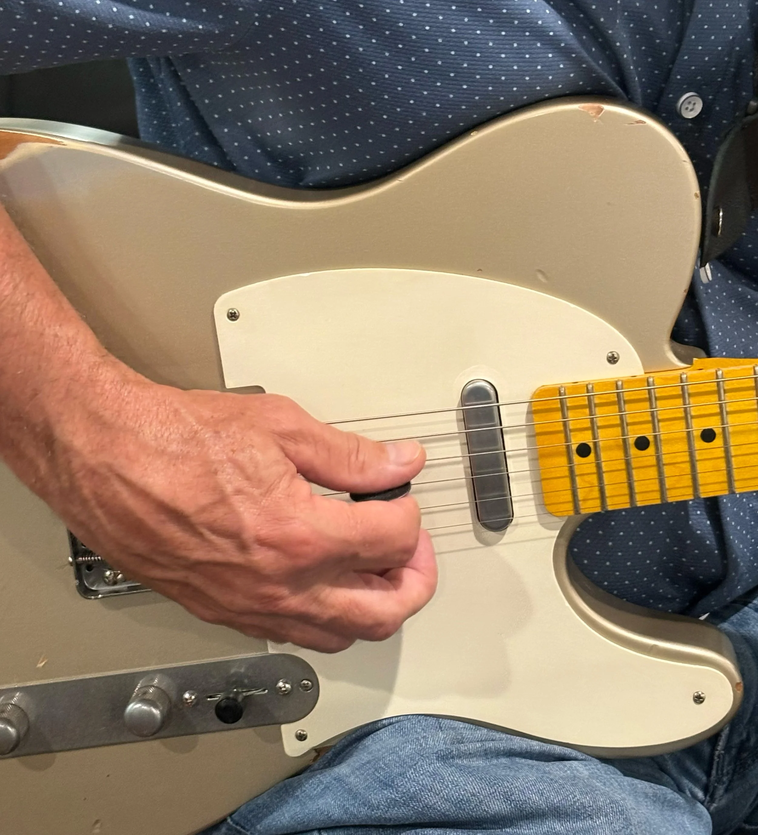 Close-up of hands on guitar neck during lesson
