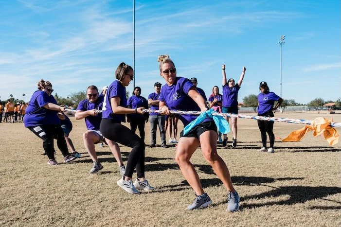 Guests playing tug-of-war during a private outdoor event