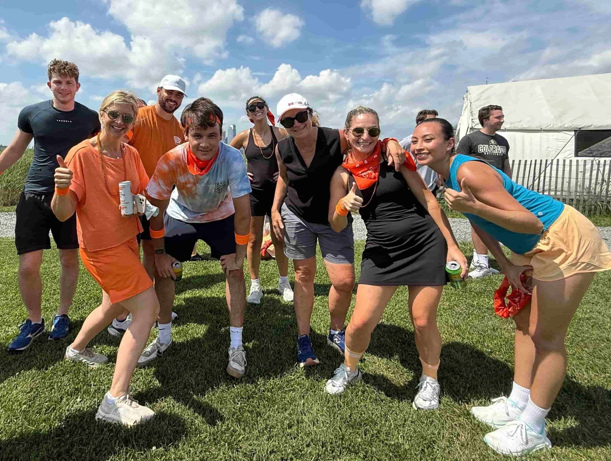 Team members smiling in tie-dye shirts at an outdoor team building field day in Atlanta