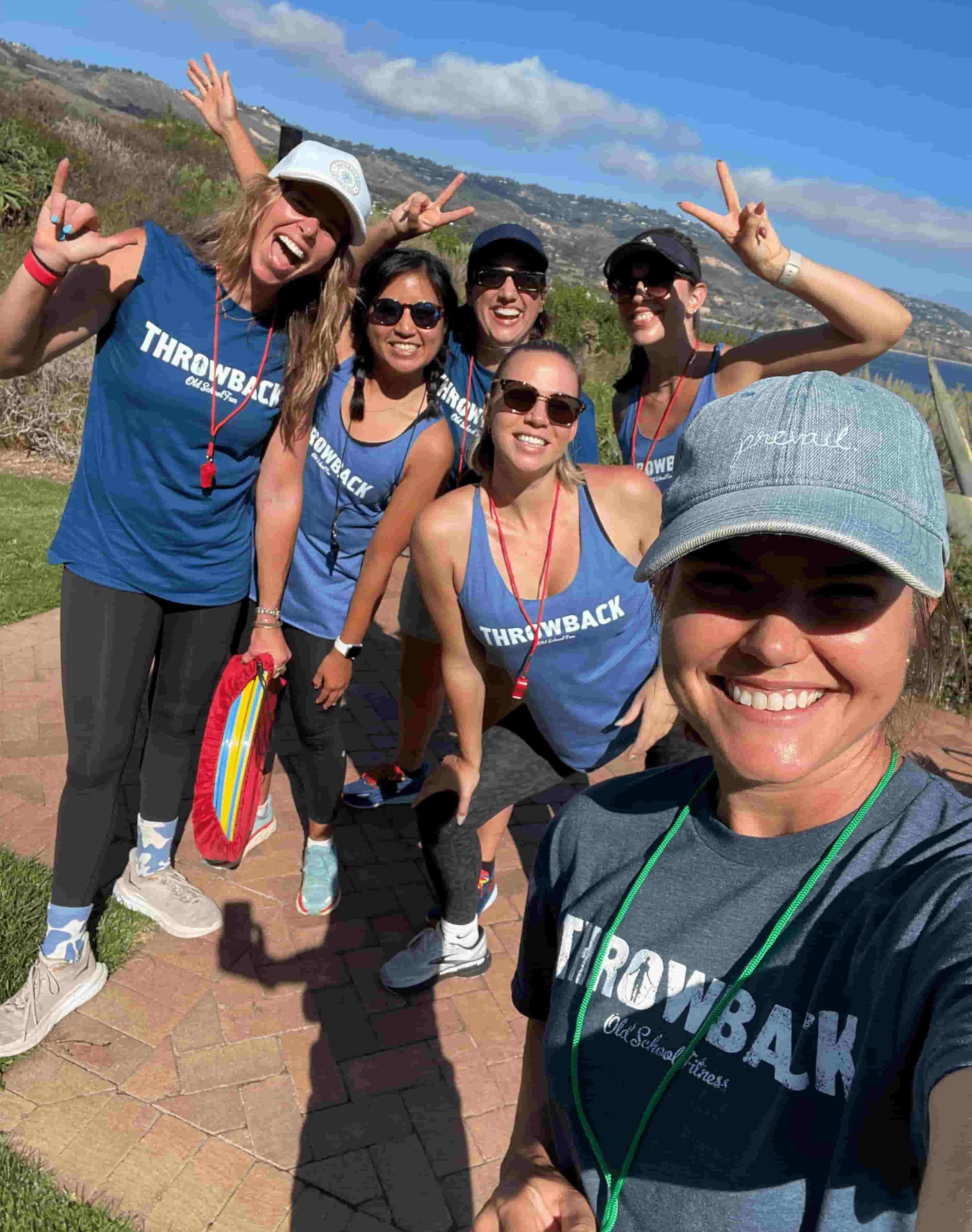 Throwback team building staff in branded shirts at a corporate event on the Los Angeles coast