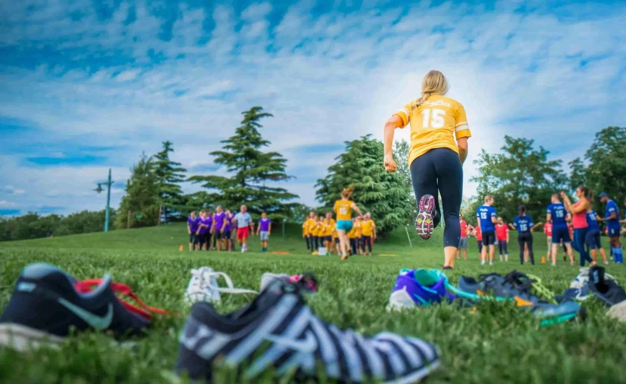 Employee mid-run past a row of sneakers during a corporate field day running game in Atlanta