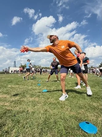 Friends enjoying outdoor activities and laughter, showcasing creative and different birthday party ideas for adults