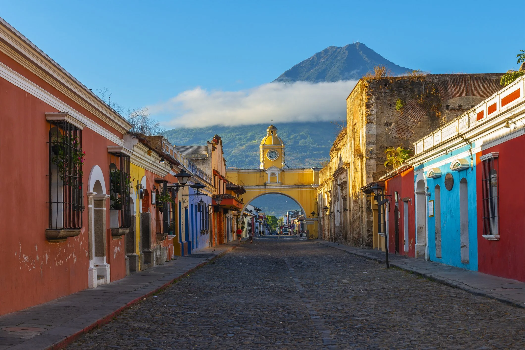 The Arch of Santa Catalina in Antigua Guatemala.  With a view of Volcan Agua in the background. El Arco de Santa Catalina en Antigua Guatemala con vista del Volcan De Agua a lo lejos.