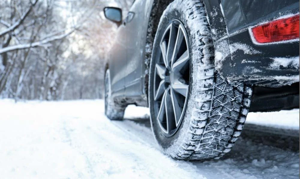 Car Driving Through Snow Tire Close Up