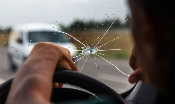 Man Driving with Crack on Windshield