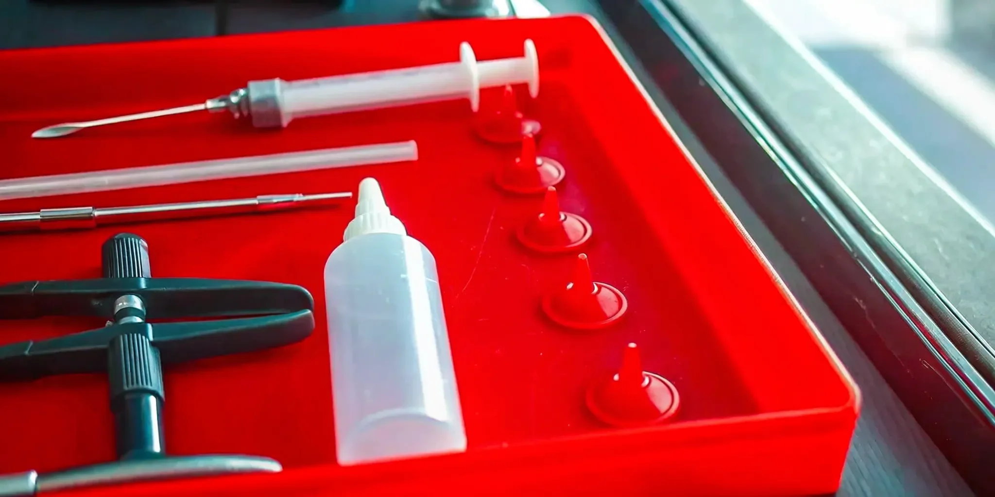 A car window chip repair kit with tools and resin for DIY windshield repair.
