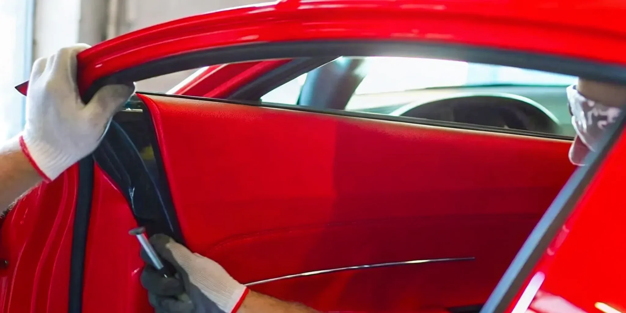 Professional technician performing a passenger side window glass replacement.