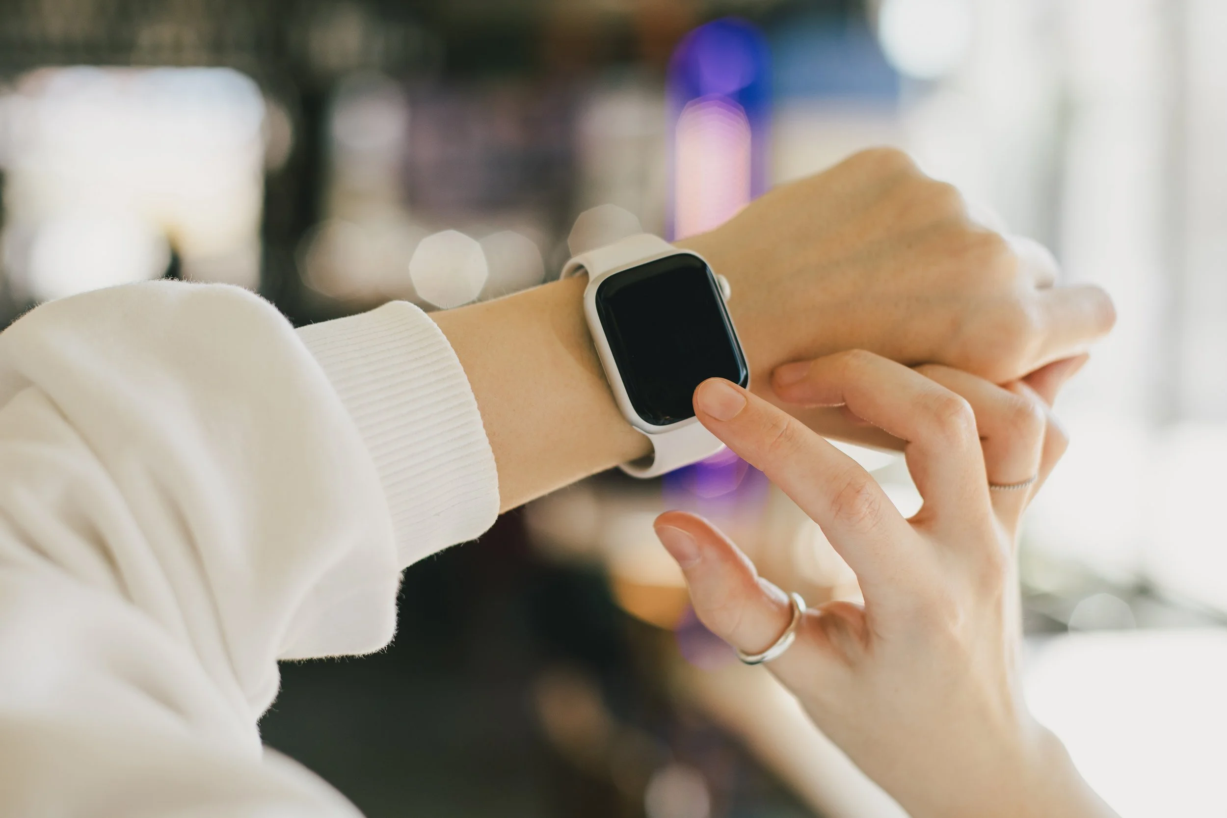 Tapping finger on Apple watch with myQTwave logo app on it