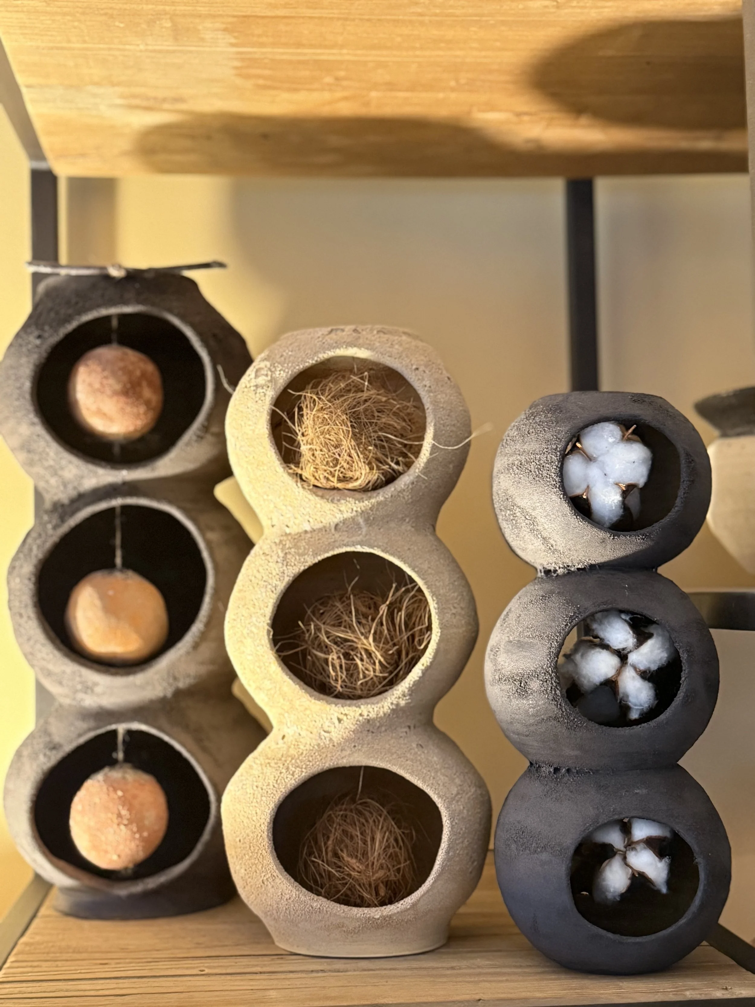 Susan Siegel, wish pots containing clay beads, sandal wood pods and cotton bolls.