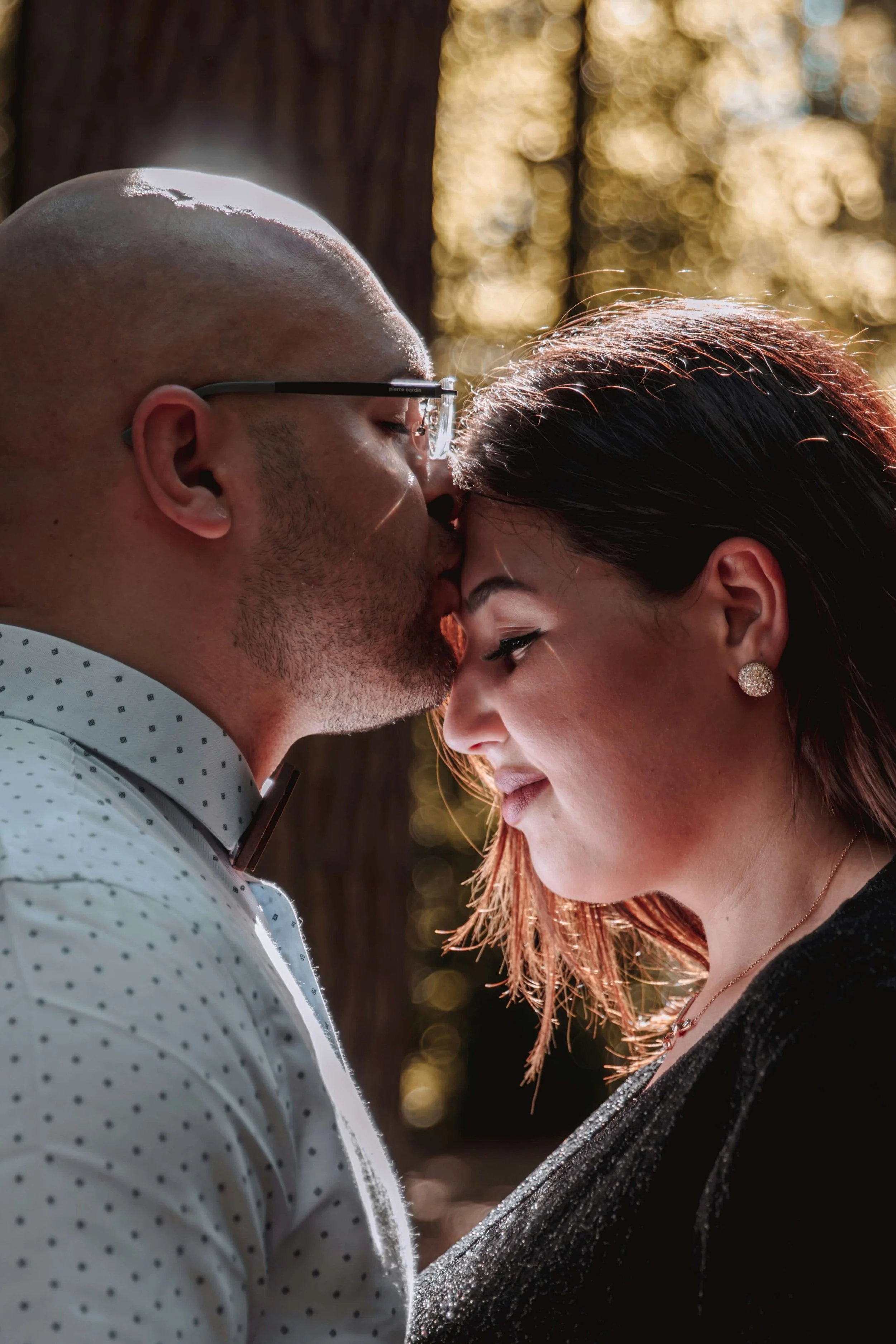 A couple sharing a kiss with their foreheads touching representing harmony and alignment after couples therapy