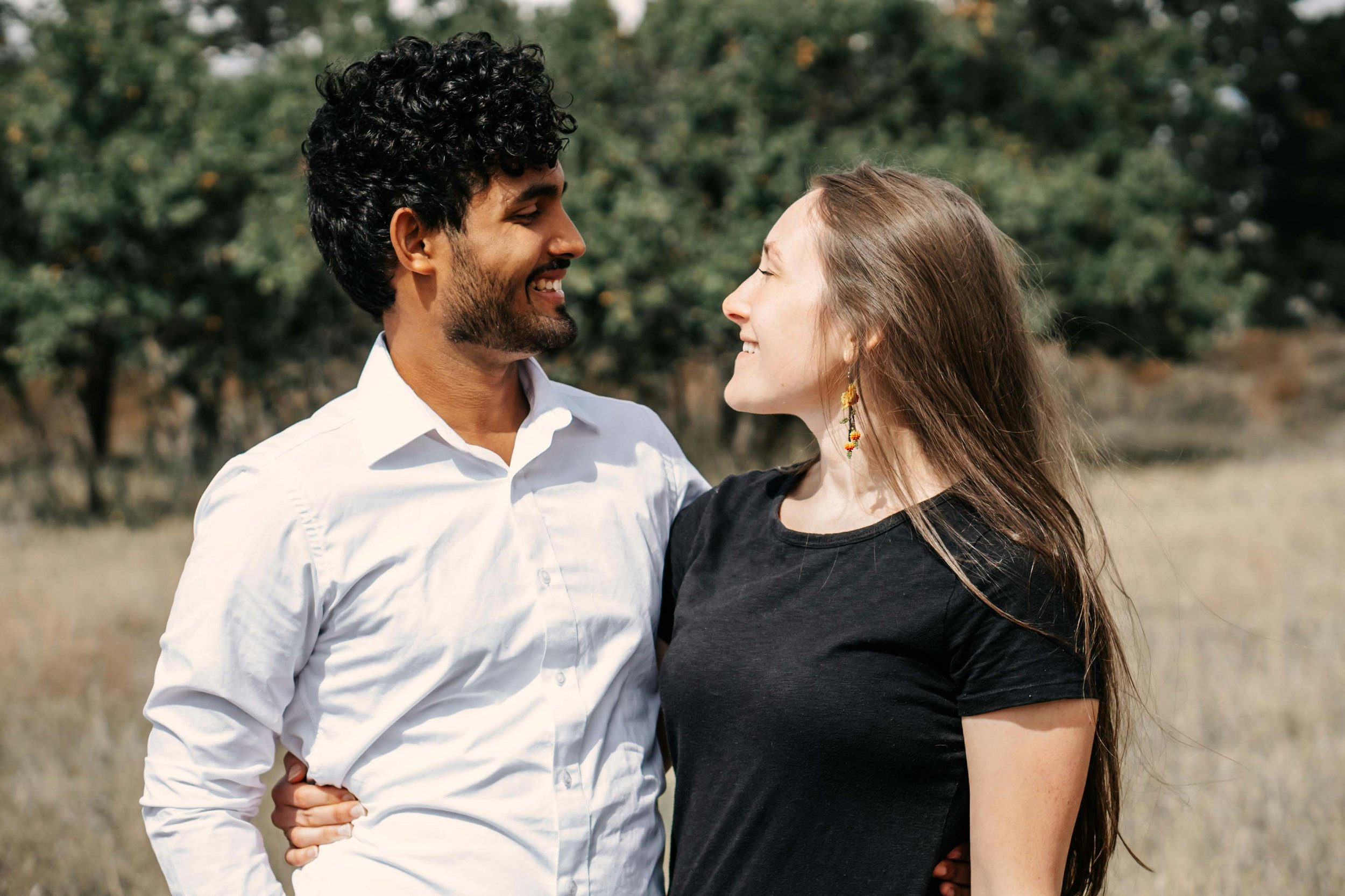 couple-laughing-together-communication-conflict-therapy-needham-ma.jpg Alt text: Couple standing close and laughing together outdoors, representing open communication in couples therapy in Needham, MA