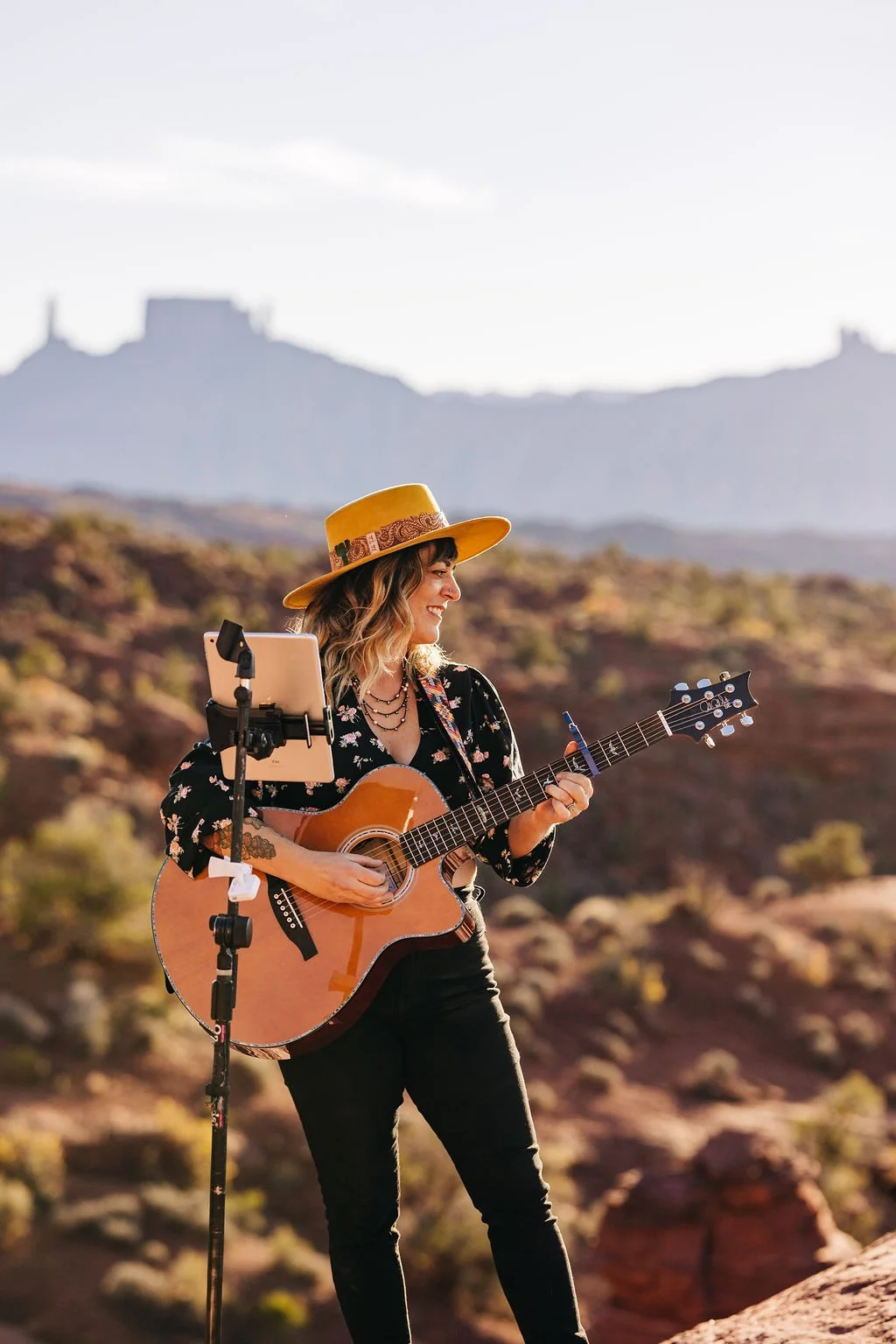 Toni Sicola performing solo with acoustic guitar near Castle Rock