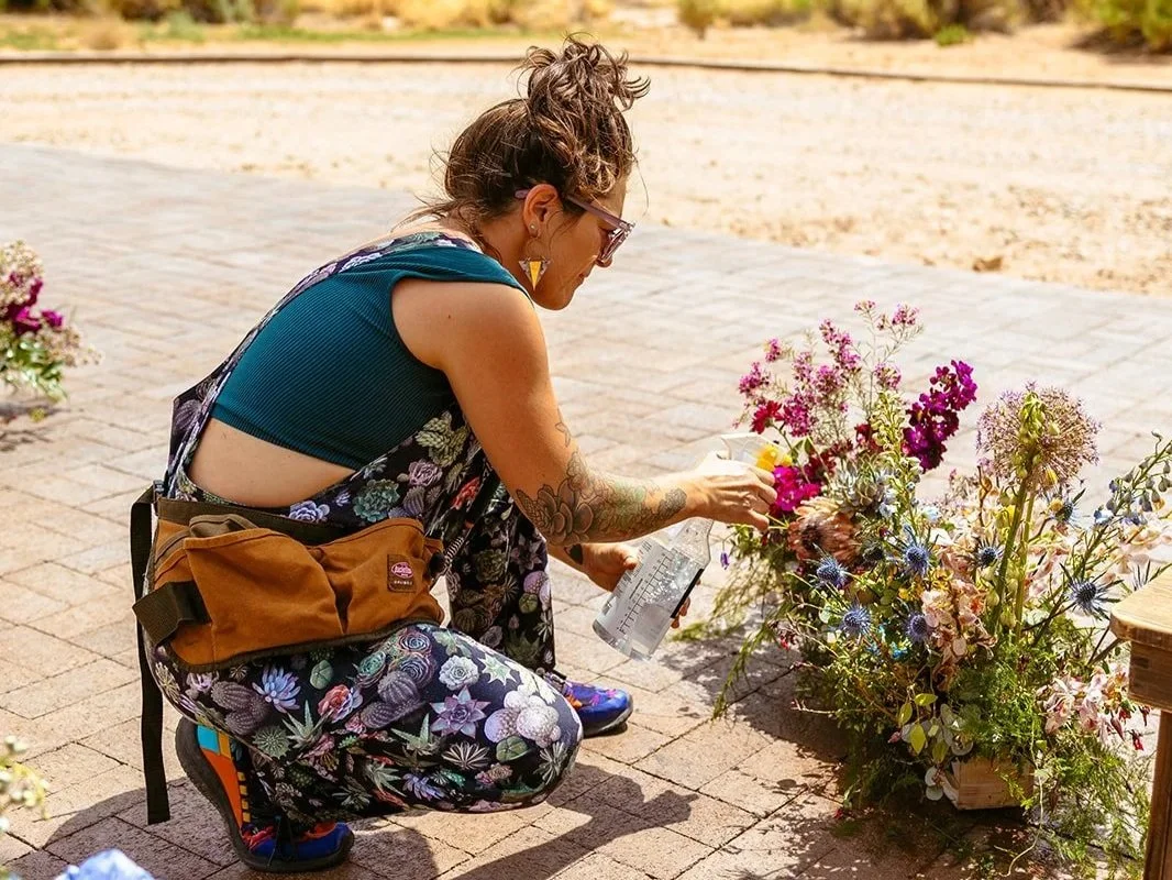 Moab florist freshens up the flowers for a ceremony at Red Earth Venue.