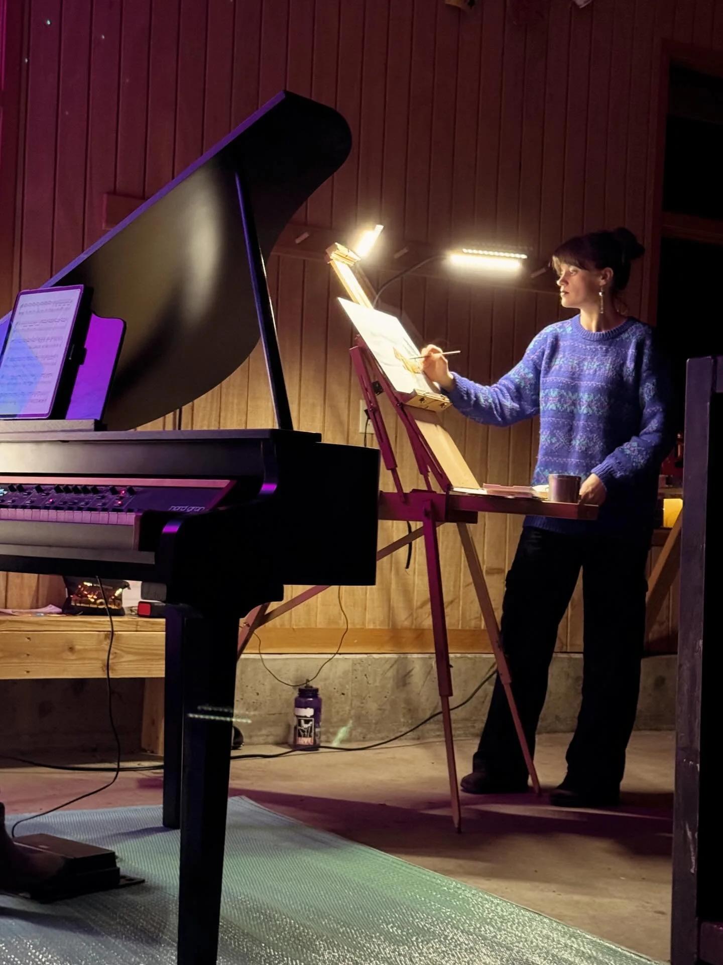 An absolute dreamy experience, painting live for @paula.dreyer.music candlelight ski concerts last weekend 😍 I painted two separate paintings for the two concerts. One was acrylic, the other watercolor (that was kinda trippy switching between those 