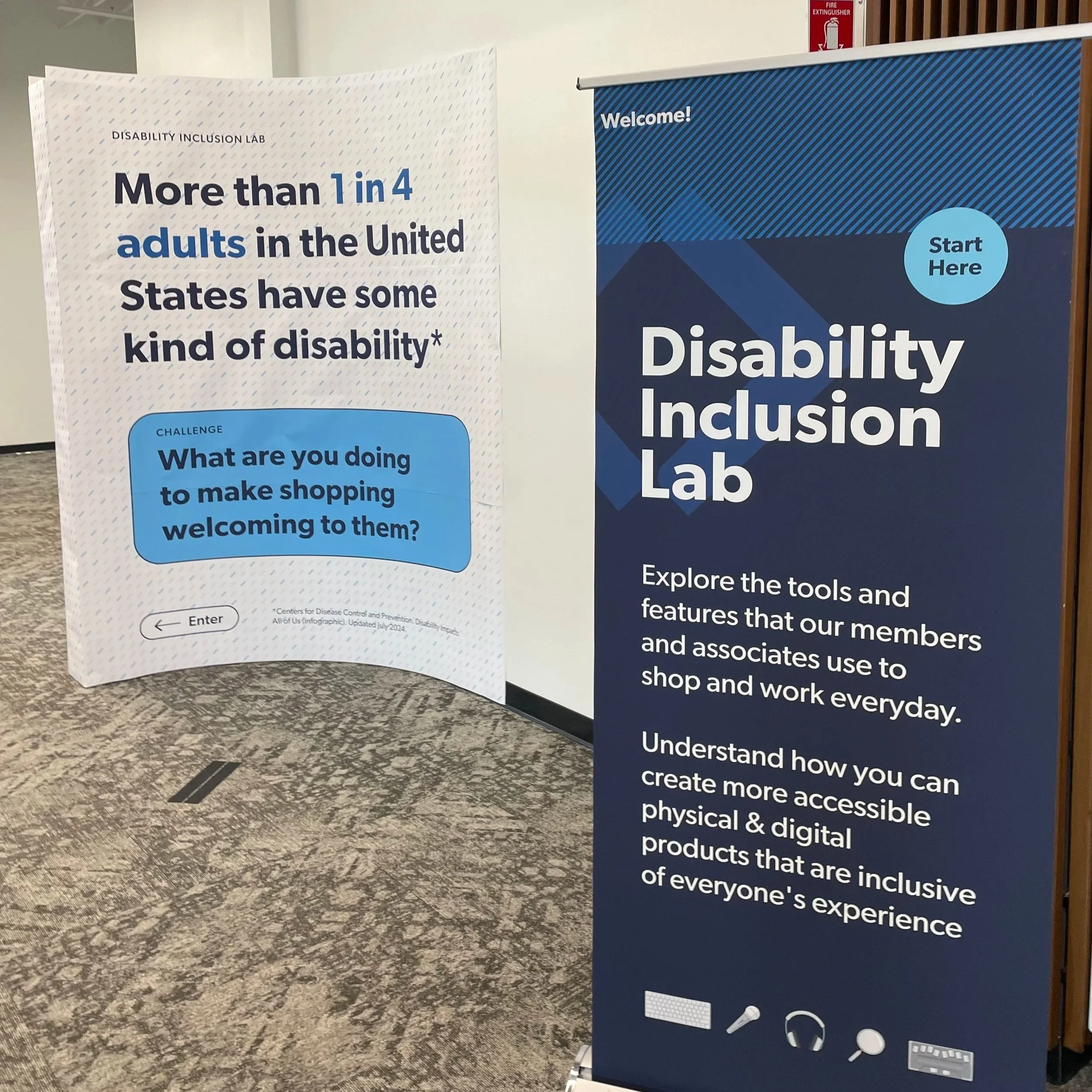 Welcome signage for the Disability Inclusion Lab, featuring a banner introducing the lab and a curved wall with textured floor markings that signal stopping points for visitors using a cane.