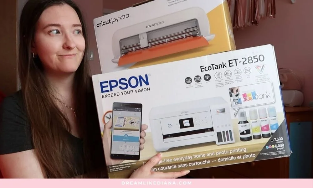 A woman smiles while holding boxes for a Cricut Joy Xtra and Epson EcoTank printer. The scene conveys excitement and anticipation for crafting.