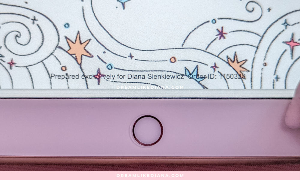 A close-up of a tablet screen showing a whimsical design with swirling lines, stars, and dots in pastel colors. Below, a pink casing with a round button is partially visible. The atmosphere is playful and light.