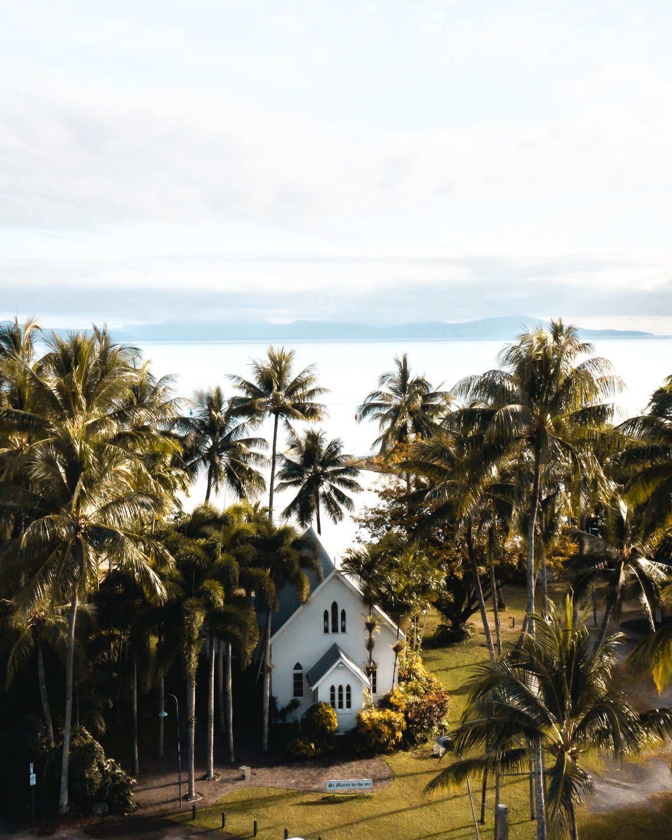 St Mary's by the Sea is a heritage-listed church right next to the beach at Port Douglas, Queensland, Australia, surrounded by beautiful coconut palm trees.