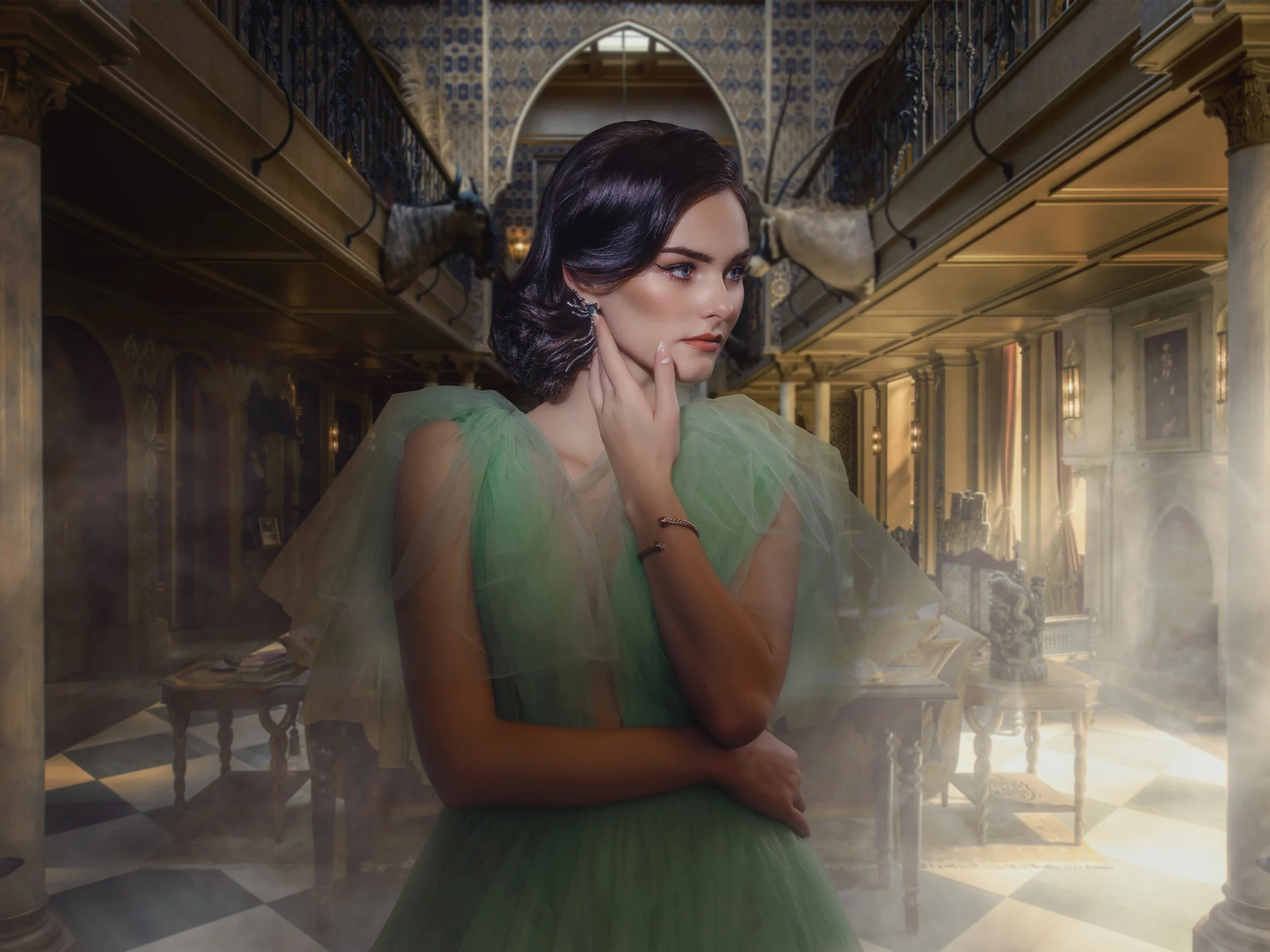 A young woman with dark hair, wearing a green dress with sheer puffed sleeves, is standing in an elegant, richly decorated room with high ceilings, ornate columns, and antique furniture. She appears to be deep in thought, with one hand touching her f