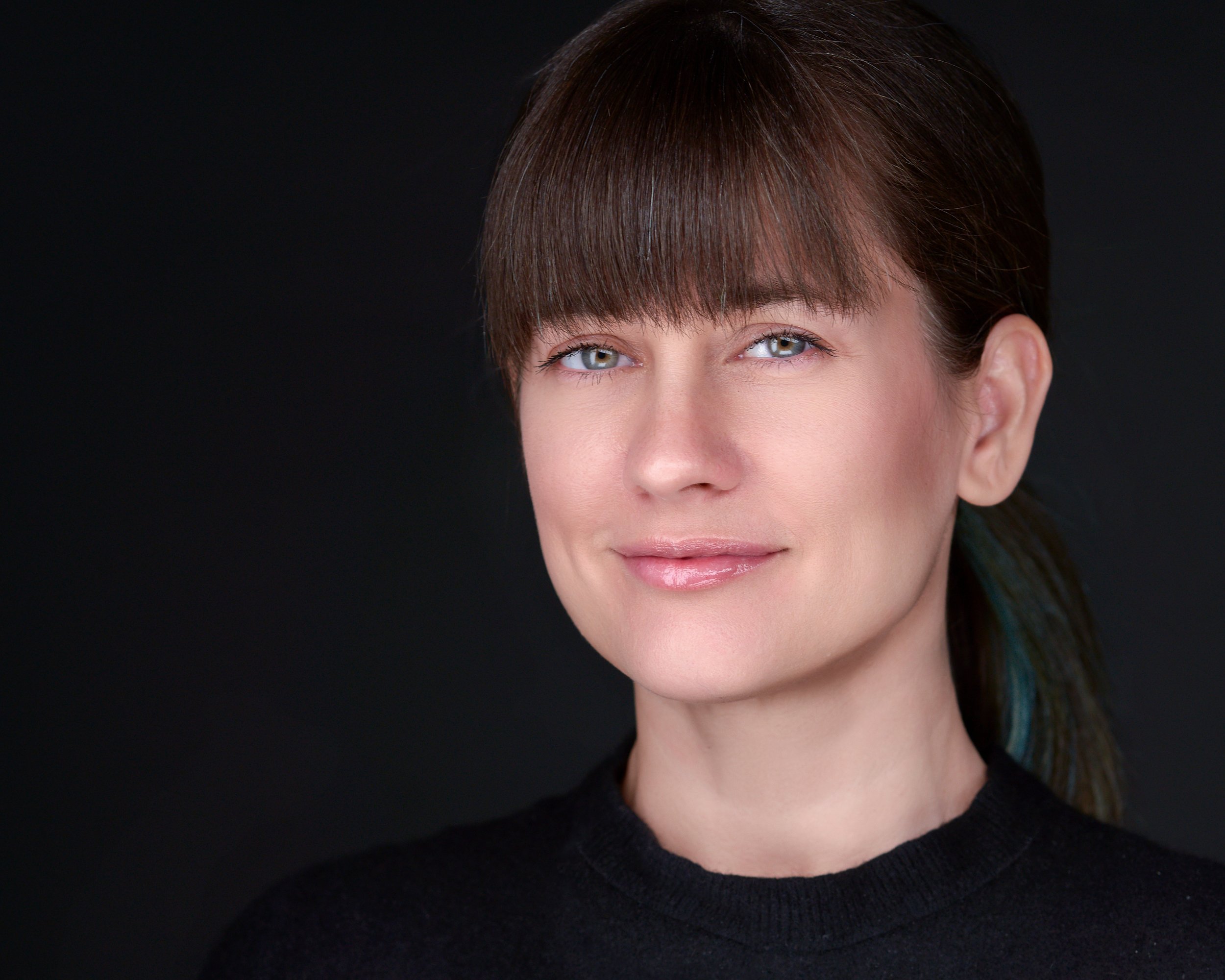 Professional Headshot Portrait with Natural Lighting and Dark Background.jpg