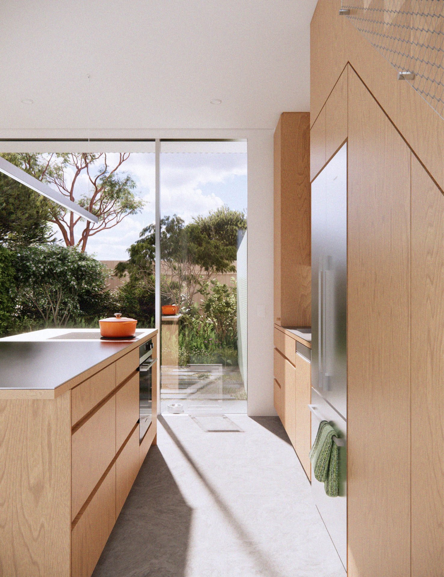 Open-plan kitchen in a brand-new townhouse for sale, featuring induction cooking, timber cabinetry, and a private courtyard.