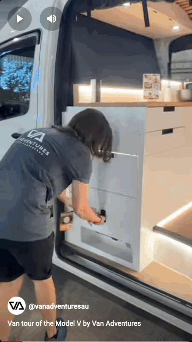 Melissa from Van Adventures giving a tour of the fully equipped kitchen in the Model V campervan, highlighting its stylish and functional design.