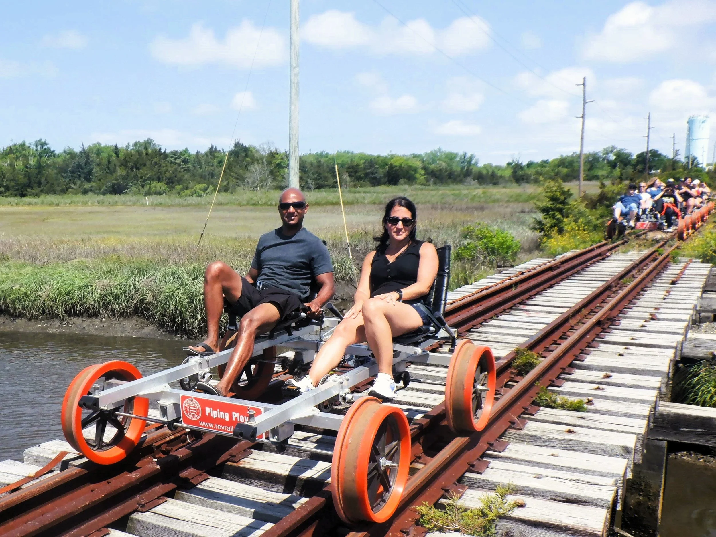 a couple riding a rail bike across a bridge in Cape May, New Jersey