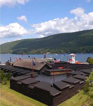 fort surrounded by flags near the lake