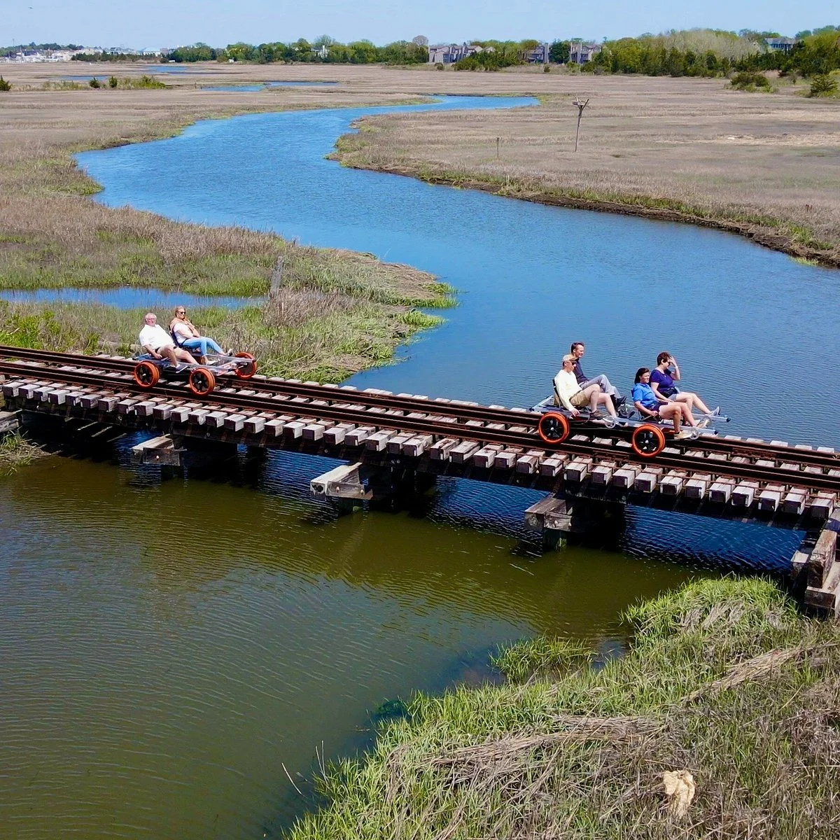 Rail bikers cross a marsh over a small bridge in Cape May, New Jersey