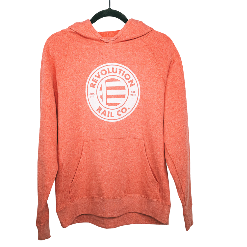 Orange Revolution Rail hoodie hanging on a black clothing hanger.