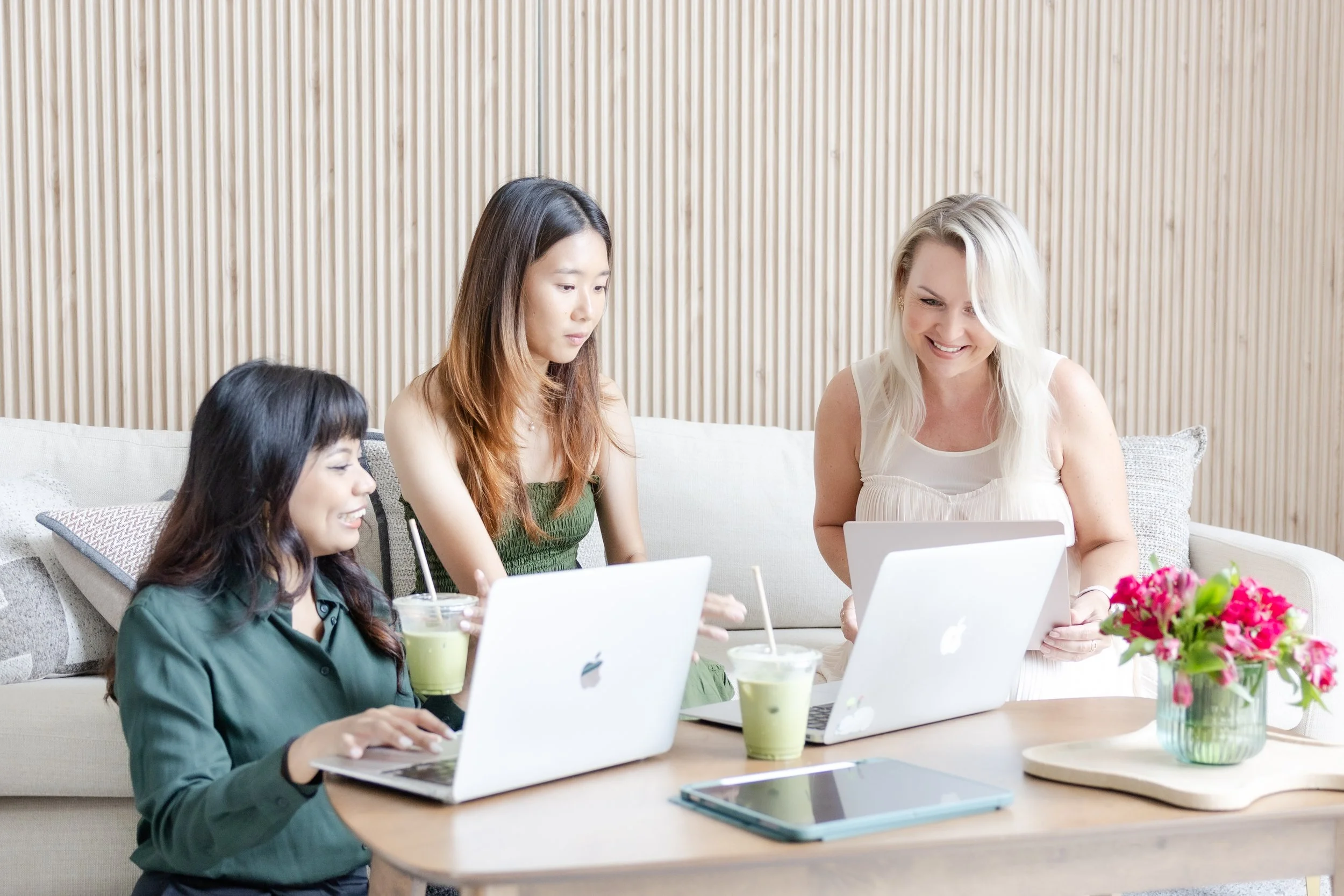 Social media marketing agency team collaborating around a table, planning an authentic founder-led content strategy that balances AI tools with human creativity and brand storytelling