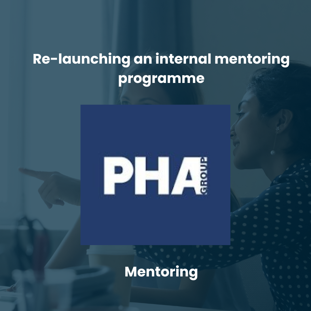 A woman in a polka dot shirt is pointing at something during a discussion in a professional setting. Overlayed text mentions re-launching an internal mentoring program by PHA Group.