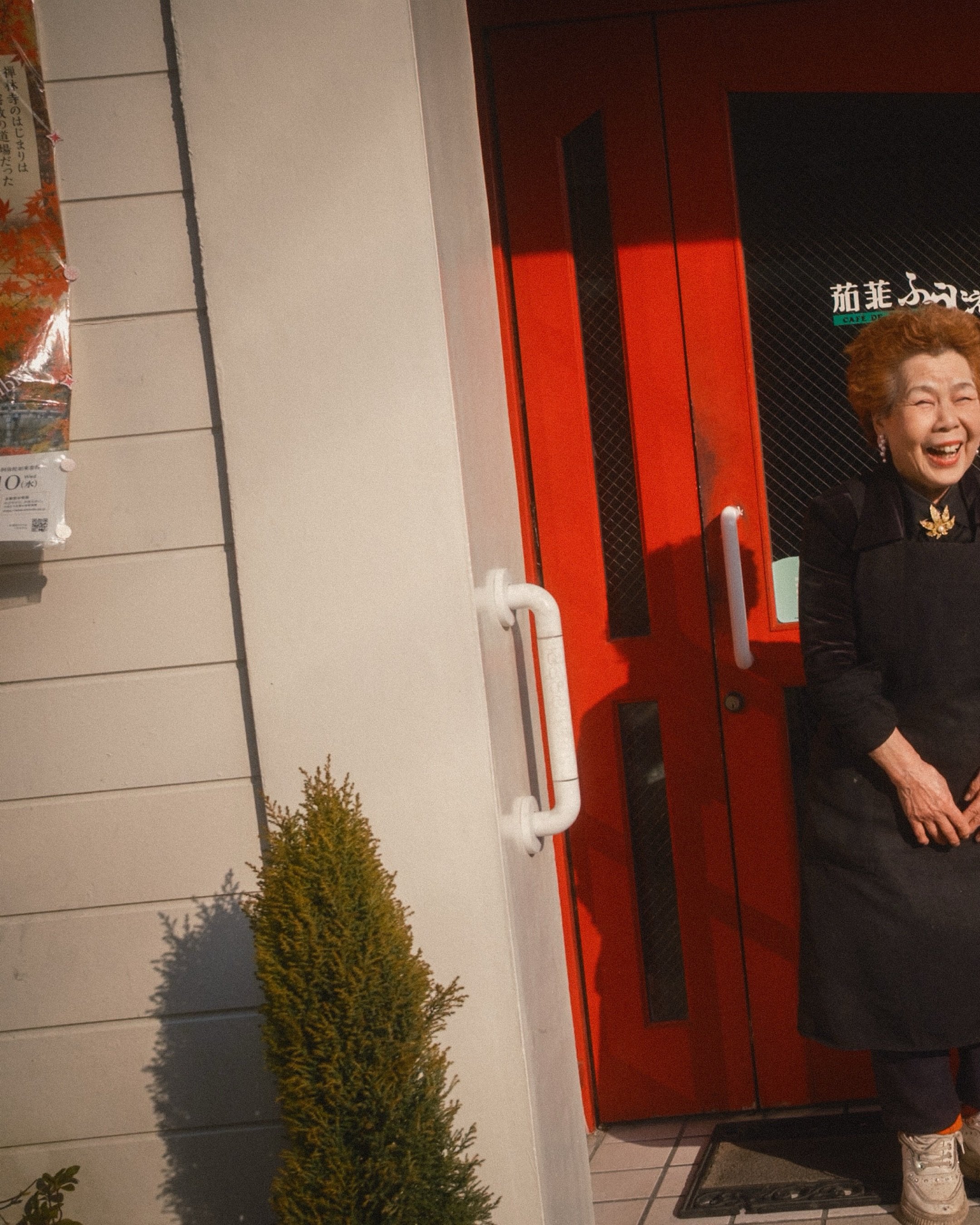 I like to call Grandma-San. She wore white platform sneakers with rhinestones stretched around the top, a black velvety jacket, pearls, and a gold-leaf brooch pinned just right. Her red hair, about 2 months past fresh, almost matched the trim paint i