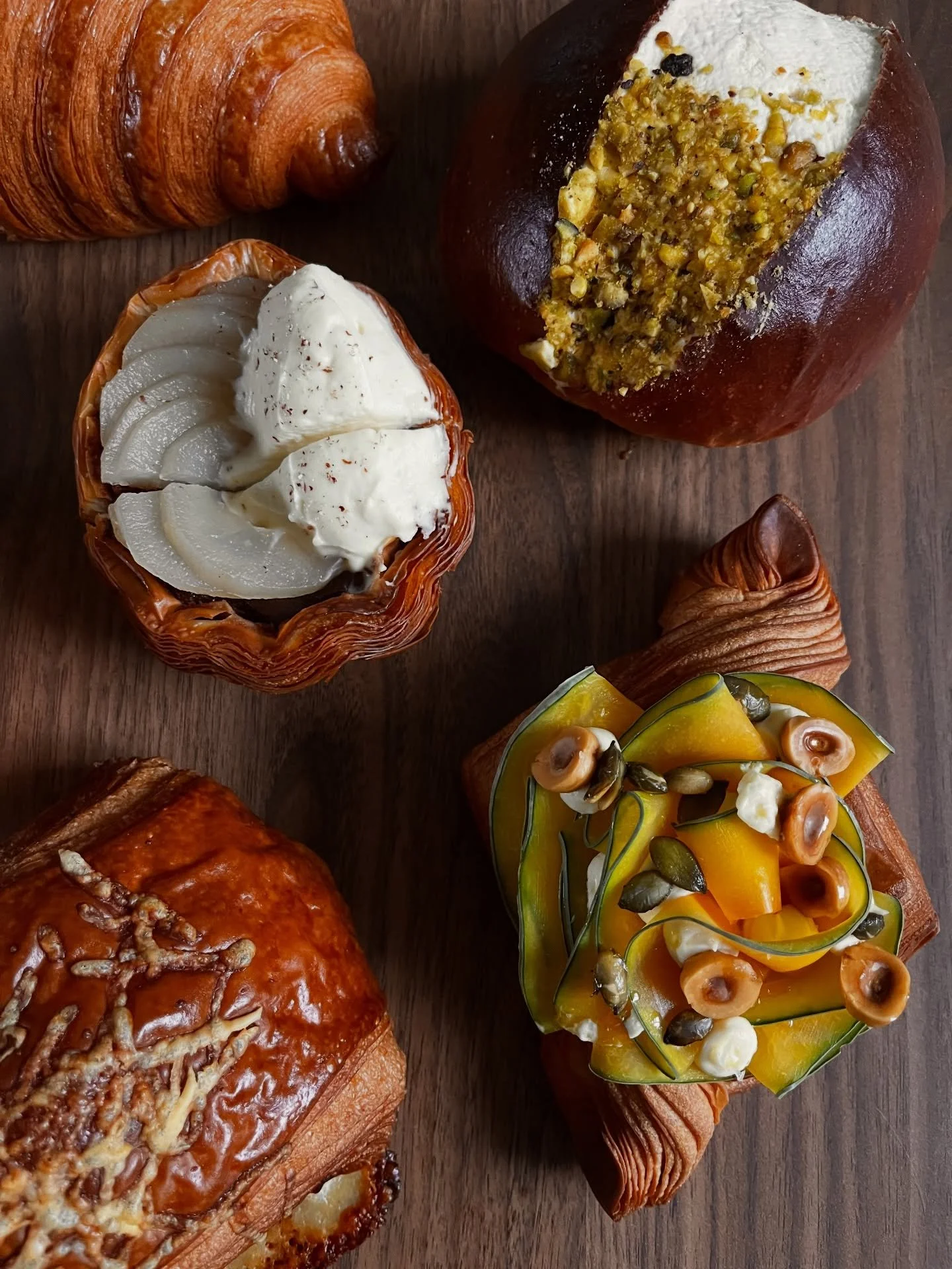 Oak Smoked Crown Prince Pumpkin, Whipped Goat Cheese + Toasted Hazelnuts.

Buttery, croissant layers filled with a velvety smooth pumpkin pur&eacute;e topped with paper thin slices of Crown Prince pumpkin, that we oak smoked in the bakery. 
Whipped g