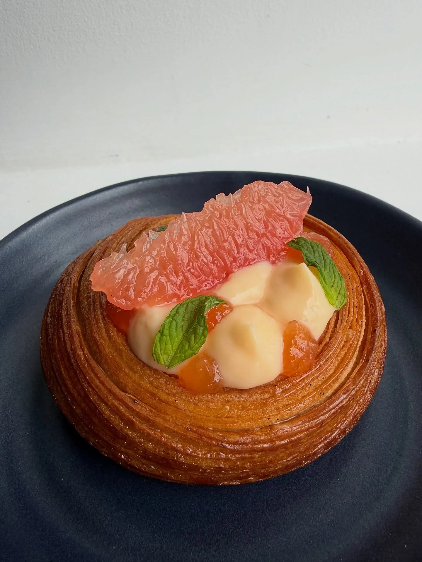 Grapefruit + Mint.

Ruby grapefruit curd, ruby grapefruit marmalade and micro mint in a buttery croissant tart.

One of our April specials on the counter this weekend 🧡