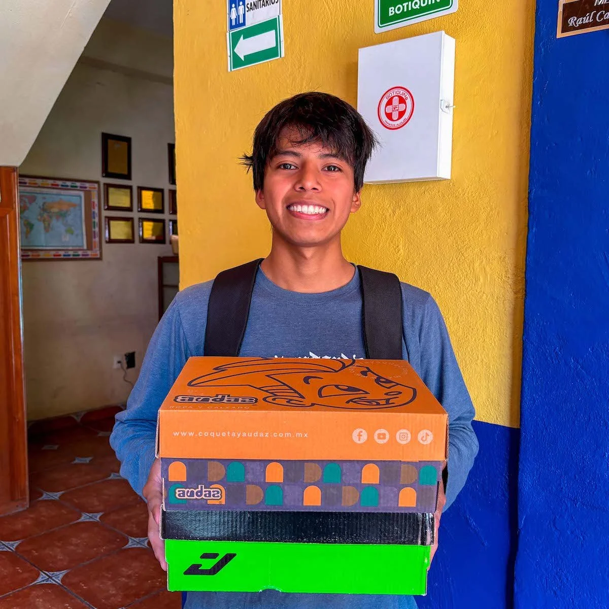 student-holding-shoe-boxes.jpg